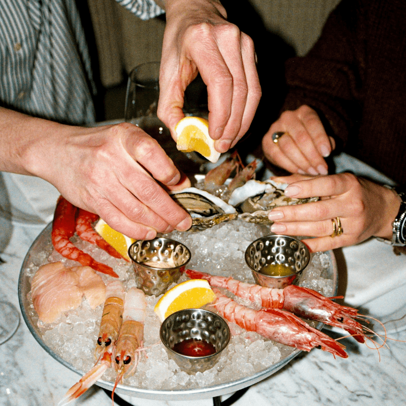 Group-of-people-sharing-a-fish-platter